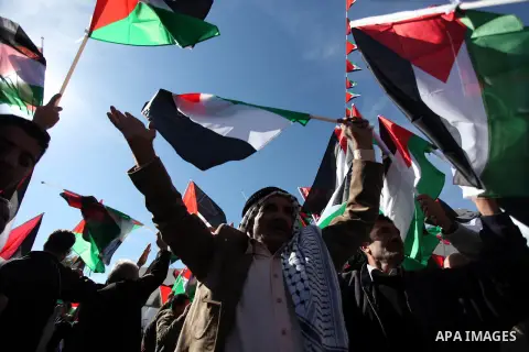 Palestinians wave national flags as they celebrate their successful bid for UN non-member observer state status, in the West Bank city of Ramallah on December 2, 2012, Palestinian President Mahmoud Abbas arrived to the W...