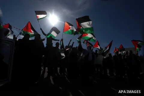 Palestinians wave national flags as they celebrate their successful bid for UN non-member observer state status, in the West Bank city of Ramallah on December 2, 2012, Palestinian President Mahmoud Abbas arrived to the W...