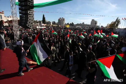 Palestinians wave national flags as they celebrate their successful bid for UN non-member observer state status, in the West Bank city of Ramallah on December 2, 2012, Palestinian President Mahmoud Abbas arrived to the W...