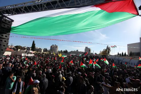 Palestinians wave national flags as they celebrate their successful bid for UN non-member observer state status, in the West Bank city of Ramallah on December 2, 2012, Palestinian President Mahmoud Abbas arrived to the W...