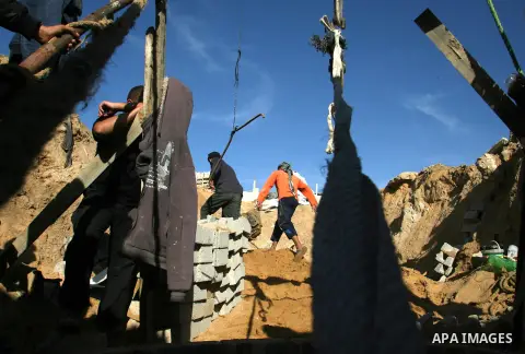 Palestinian labourers repair a bombed smuggling tunnel linking the Gaza Strip to Egypt, in Rafah, on December 2, 2012. Israeli airforce jets bombed most of the smuggling tunnels in the southern Gaza Strip during its war...