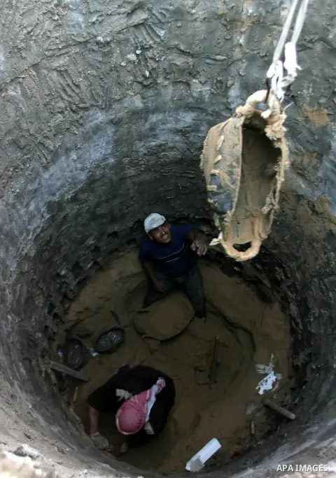 Palestinian labourers repair a bombed smuggling tunnel linking the Gaza Strip to Egypt, in Rafah, on December 2, 2012. Israeli airforce jets bombed most of the smuggling tunnels in the southern Gaza Strip during its war...