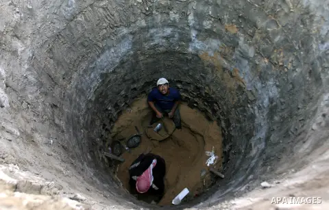 Palestinian labourers repair a bombed smuggling tunnel linking the Gaza Strip to Egypt, in Rafah, on December 2, 2012. Israeli airforce jets bombed most of the smuggling tunnels in the southern Gaza Strip during its war...