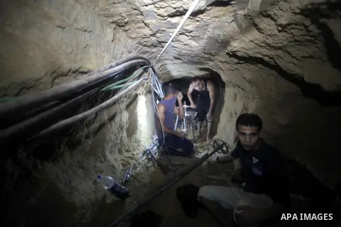 Palestinian labourers repair a bombed smuggling tunnel linking the Gaza Strip to Egypt, in Rafah, on December 2, 2012. Israeli airforce jets bombed most of the smuggling tunnels in the southern Gaza Strip during its war...