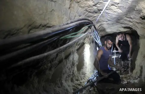 Palestinian labourers repair a bombed smuggling tunnel linking the Gaza Strip to Egypt, in Rafah, on December 2, 2012. Israeli airforce jets bombed most of the smuggling tunnels in the southern Gaza Strip during its war...