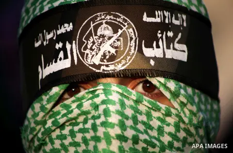 A Palestinian member of al-Qassam brigades, the armed wing of the Hamas movement, takes part in an anti-Israel parade in Gaza City December 2, 2012. Eight days of Israeli air strikes on Gaza and cross-border Palestinian...