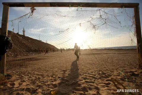Palestinian youths play football at the beach in Gaza City on December 2, 2012. As part of the truce that ended eight days of cross-boarder fighting between Israel and Gaza militants, Israel's naval blockade of the coast...