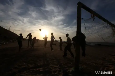 Palestinian youths play football at the beach in Gaza City on December 2, 2012. As part of the truce that ended eight days of cross-boarder fighting between Israel and Gaza militants, Israel's naval blockade of the coast...