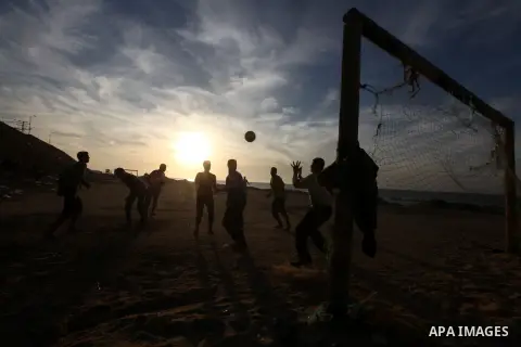 Palestinian youths play football at the beach in Gaza City on December 2, 2012. As part of the truce that ended eight days of cross-boarder fighting between Israel and Gaza militants, Israel's naval blockade of the coast...
