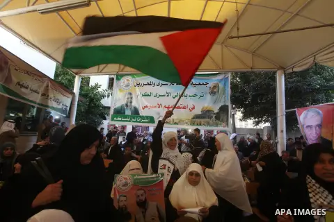 Palestinian women hold pictures of their prisoned relatives in Israeli jails as they gather in a weekly activity calling for their liberty at the Red Cross headquarters in Gaza City on December 03, 2012. Photo by Ashraf...