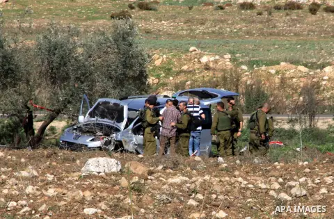Israeli soldiers inspect the damage cars of Israeli forces from the Shin Bet internal security agency and Hatem Shadid, a Palestinian who was shot dead earlier the agency members after he rammed their car and attacked th...