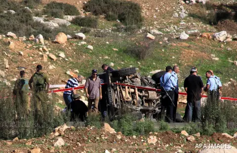 Israeli soldiers inspect the damage cars of Israeli forces from the Shin Bet internal security agency and Hatem Shadid, a Palestinian who was shot dead earlier the agency members after he rammed their car and attacked th...