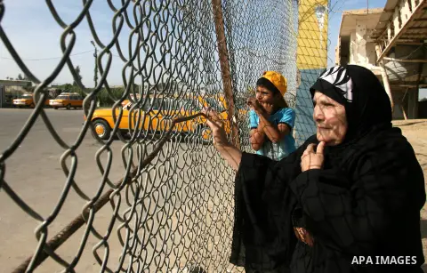 Palestinian relatives of Fatah movement members wait at Rafah crossing border between Gaza strip and Egypt, as they pass the crossing on December 03, 2012. Hamas movement allowed to Fatah members to enter Gaza Strip afte...