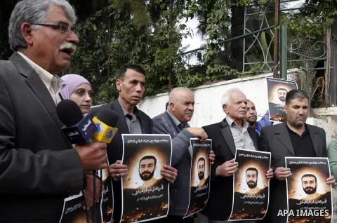 Palestinians hold portraits of prisoner Samer Issawi who is on a hunger strike, as they protest for his release in Jerusalem, 03 December 2012. Photo by Mahfouz Abu Turk