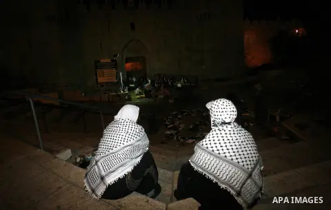 Palestinian women sit in front of Damascus gate near al-Aqsa mosque Islam's third holiest site, in the old city of Jerusalem on December 03, 2012. Photo by Mahfouz Abu Turk