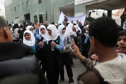 Palestinian children with special needs walk past buildings destroyed during the Gaza-Israeli conflict during a demonstration on the occasion of the UN International Day of People with Disability, on December 4, 2012 in...