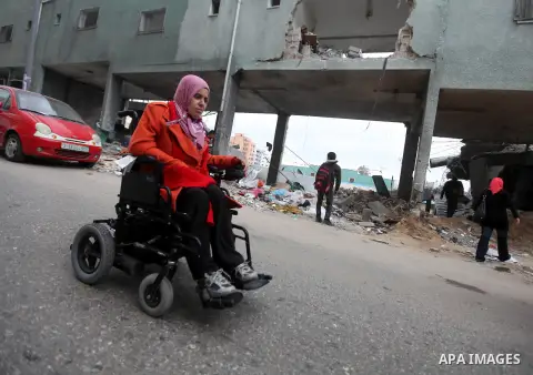 Palestinian children with special needs walk past buildings destroyed during the Gaza-Israeli conflict during a demonstration on the occasion of the UN International Day of People with Disability, on December 4, 2012 in...