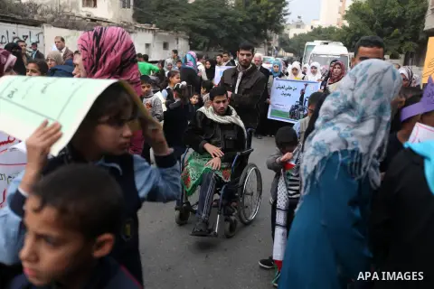 Palestinian children with special needs walk past buildings destroyed during the Gaza-Israeli conflict during a demonstration on the occasion of the UN International Day of People with Disability, on December 4, 2012 in...