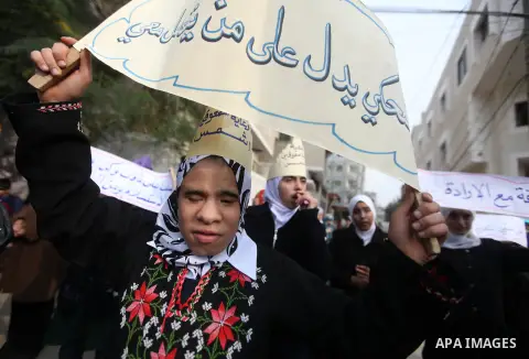 Palestinian children with special needs walk past buildings destroyed during the Gaza-Israeli conflict during a demonstration on the occasion of the UN International Day of People with Disability, on December 4, 2012 in...