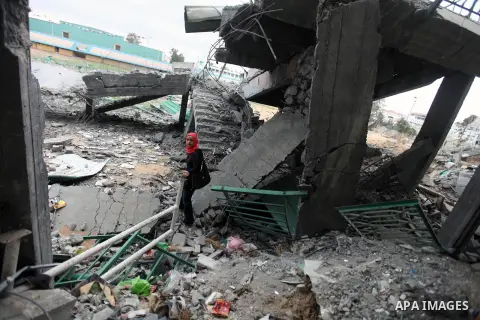 Palestinian children with special needs walk past buildings destroyed during the Gaza-Israeli conflict during a demonstration on the occasion of the UN International Day of People with Disability, on December 4, 2012 in...