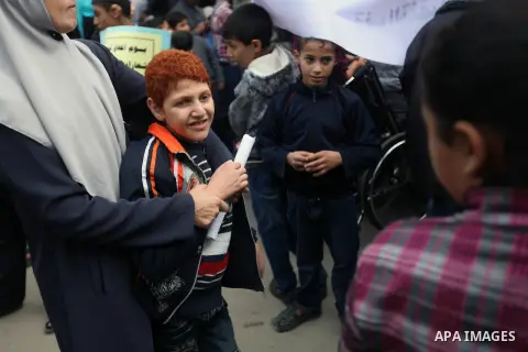 Palestinian children with special needs walk past buildings destroyed during the Gaza-Israeli conflict during a demonstration on the occasion of the UN International Day of People with Disability, on December 4, 2012 in...