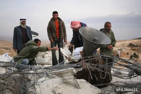 Palestinian men search through the rubble of a mosque that was demolished by Israeli forces in the West Bank village of al-Mufaqara, south of Hebron, on December 04, 2012. Photo by Mamoun Wazwaz