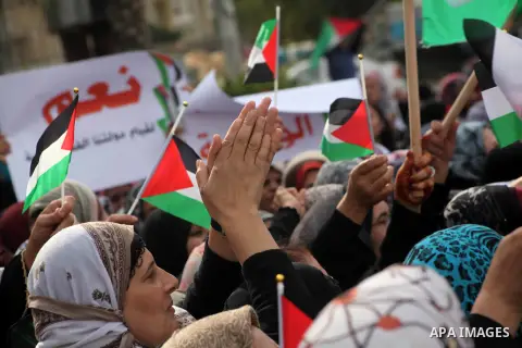 Palestinian women hold national flags during a rally to support reconciliation between rival Palestinian factions in Gaza city on 04 Dec, 2012. Palestinian President Mahmud Abbas pledged Sunday to resume efforts at recon...