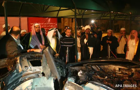 Members of delegation of Association of Muslim Scholars look at a Palestinian devastating car immediately after arrives to Gaza strip at Rafah crossing border southern Gaza strip, Dec 04, 2012. The members of the delegat...