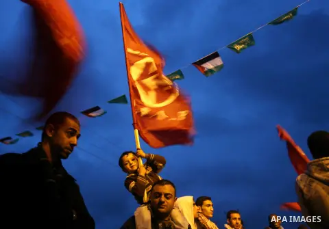 Palestinians hold flags of PFLP during a rally to receive PFLP's Leila Khaled at Rafah crossing border southern Gaza strip, Dec 04, 2012. Khaled is a member of the Popular Front for the Liberation of Palestine (PFLP) and...