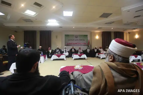 Palestinian Minister of Religious Affairs in Gaza strip Ismail Radwan (not seen) meets with the members of delegation of Association of Muslim Scholars in Gaza city, Dec 04, 2012. The delegation is expected to meet with...