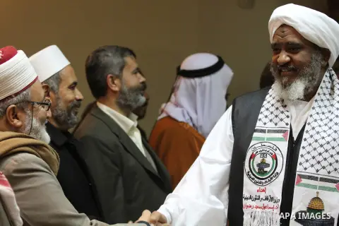 Palestinian Minister of Religious Affairs in Gaza strip Ismail Radwan (not seen) meets with the members of delegation of Association of Muslim Scholars in Gaza city, Dec 04, 2012. The delegation is expected to meet with...