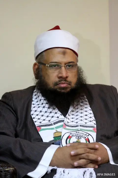Palestinian Minister of Religious Affairs in Gaza strip Ismail Radwan (not seen) meets with the members of delegation of Association of Muslim Scholars in Gaza city, Dec 04, 2012. The delegation is expected to meet with...