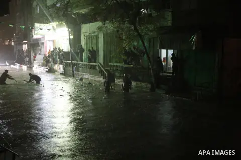 Palestinians walk at a pool of rain water in El-Shati' refugee camp in Gaza city, on Dec. 04, 2011. the onset of winter in the Palestinian territories. Photo by Mahmud Nassar