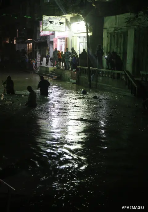 Palestinians walk at a pool of rain water in El-Shati' refugee camp in Gaza city, on Dec. 04, 2011. the onset of winter in the Palestinian territories. Photo by Mahmud Nassar