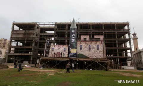 A gigantic model of a local-made M75 long range rocket is seen on stage during a preparations for Hamas rally in Gaza City December 5, 2012. Hamas armed wing said they had fired M75 rocket into Jerusalem and Tel Aviv dur...
