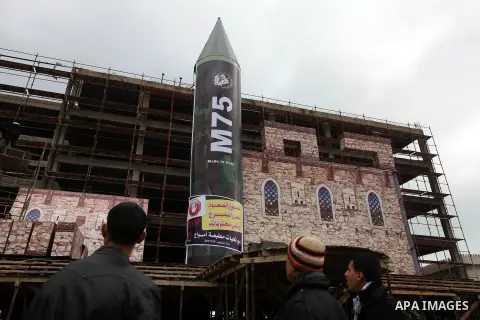 A gigantic model of a local-made M75 long range rocket is seen on stage during a preparations for Hamas rally in Gaza City December 5, 2012. Hamas armed wing said they had fired M75 rocket into Jerusalem and Tel Aviv dur...