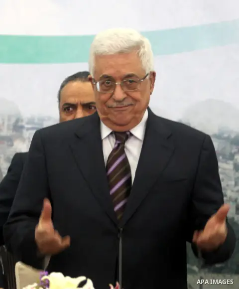 Palestinian President Mahmoud Abbas greets members of the media before a press conference in the West Bank city of Ramallah December 5, 2012. Israel moved forward on Wednesday with plans to build some 3,000 settler homes...