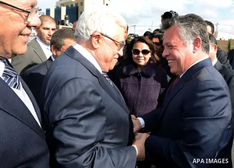 Palestinian President Mahmoud Abbas shakes hands with Jordan's King Abdullah II during their meeting in the West Bank city of Ramallah on December 6, 2012. The Jordanian King arrived in Ramallah for the first visit by a...