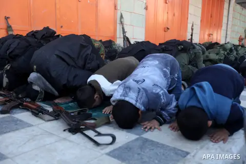 Palestinian militants of the Ezzedine al-Qassam brigade, the armed wing Hamas, attend Friday prayer as they prepare for the arrival of the Islamist movement's exiled politburo chief Khaled Meshaal who is due in the Gaza...