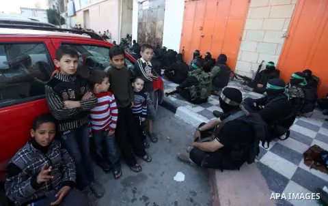 Palestinian militants of the Ezzedine al-Qassam brigade, the armed wing Hamas, attend Friday prayer as they prepare for the arrival of the Islamist movement's exiled politburo chief Khaled Meshaal who is due in the Gaza...