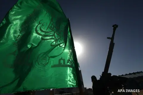 A Palestinian militant of the Ezzedine al-Qassam brigade, the armed wing Hamas, stands guard as they prepare for the arrival of the Islamist movement's exiled politburo chief Khaled Meshaal who is due in the Gaza Strip t...