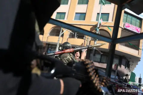 A Palestinian militant of the Ezzedine al-Qassam brigade, the armed wing Hamas, stands guard as they prepare for the arrival of the Islamist movement's exiled politburo chief Khaled Meshaal who is due in the Gaza Strip t...