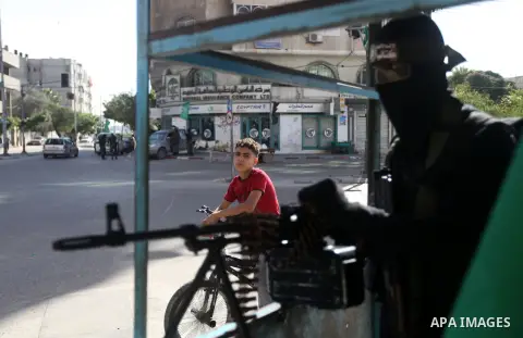 A Palestinian militant of the Ezzedine al-Qassam brigade, the armed wing Hamas, stands guard as they prepare for the arrival of the Islamist movement's exiled politburo chief Khaled Meshaal who is due in the Gaza Strip t...