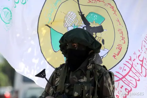 A Palestinian militant of the Ezzedine al-Qassam brigade, the armed wing Hamas, stands guard as they prepare for the arrival of the Islamist movement's exiled politburo chief Khaled Meshaal who is due in the Gaza Strip t...