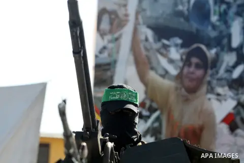 A Palestinian militant of the Ezzedine al-Qassam brigade, the armed wing Hamas, stands guard as they prepare for the arrival of the Islamist movement's exiled politburo chief Khaled Meshaal who is due in the Gaza Strip t...