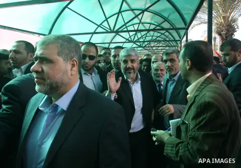 Hamas chief Khaled Meshaal and Palestinian prime minister in the Gaza Strip, Ismail Haniya wave upon Meshaal's arrival in Rafah, southern Gaza, on December 7, 2012. Meshaal is making his first-ever visit to the Gaza Stri...