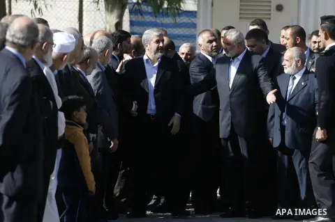 Hamas chief Khaled Meshaal and Palestinian prime minister in the Gaza Strip, Ismail Haniya walk upon Meshaal's arrival in Rafah, southern Gaza, on December 7, 2012. Meshaal is making his first-ever visit to the Gaza Stri...
