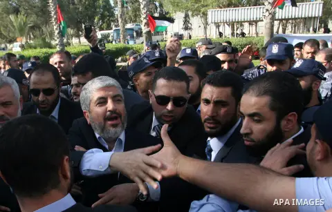 Hamas chief Khaled Meshaal shakes hands with supporters upon his arrival in Rafah, southern Gaza, on December 7, 2012. Meshaal is making his first-ever visit to the Gaza Strip amid tight security for festivities marking...