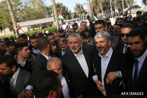 Hamas chief Khaled Meshaal and Palestinian prime minister in the Gaza Strip, Ismail Haniya walk upon Meshaal's arrival in Rafah, southern Gaza, on December 7, 2012. Meshaal is making his first-ever visit to the Gaza Stri...