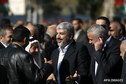 Hamas chief Khaled Meshaal shakes hands with Palestinian leaders upon his arrival in Rafah, southern Gaza, on December 7, 2012. Meshaal is making his first-ever visit to the Gaza Strip amid tight security for festivities...
